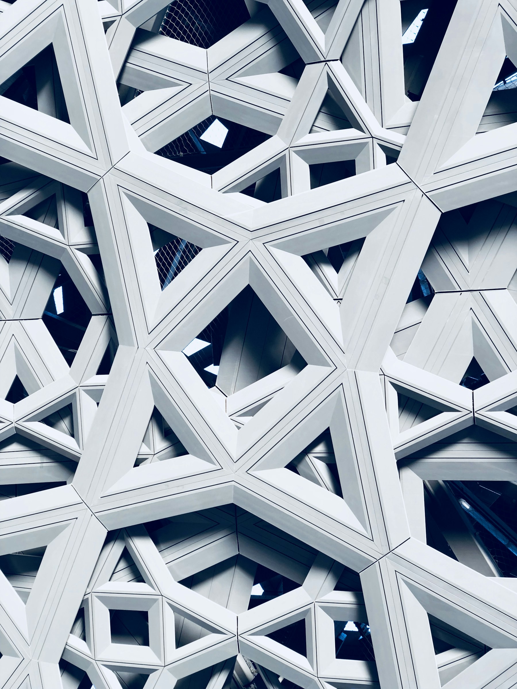 Abstract white geometric lattice of the Louvre Abu Dhabi ceiling